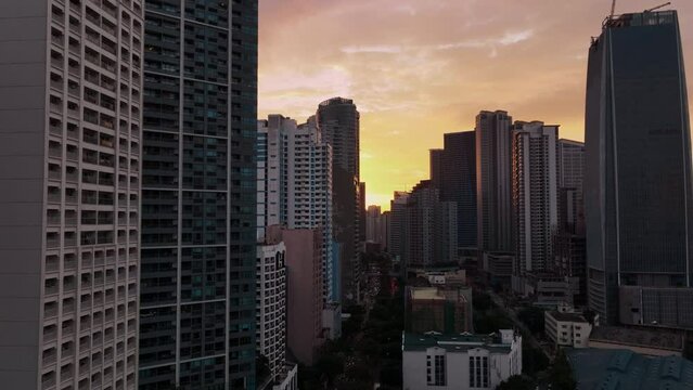 Flying Over The Skyscrapers Of Manila At Sunset, Philippines, Aerial View