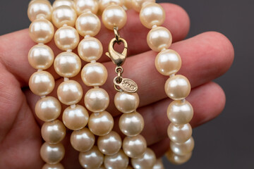 Statement pearl necklace on black background, massive unusual vintage jewelry, promotional photo for an online jewellery store