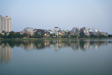 Reflection of Hanoi Downtown Skyline, Vietnam with lake and river. Financial district and business centers in smart urban city in Asia. Skyscraper and high-rise buildings.