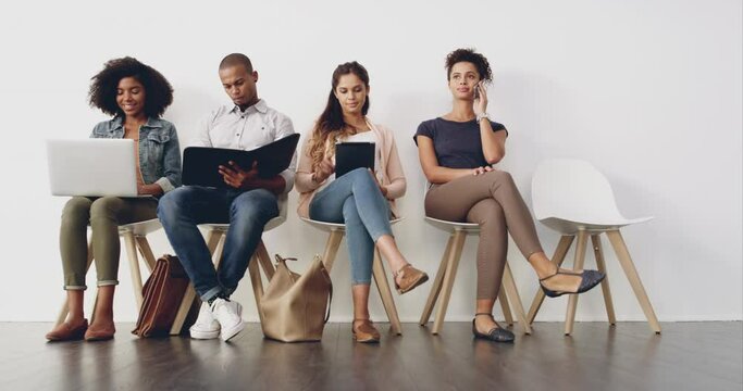 Business, people and waiting room for interview, recruitment and ready for work opportunity in career. Men, women and sitting on chair for job, hiring process and time lapse at human resource agency