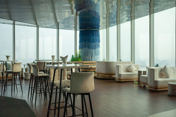 Sky bar, a restaurant or cafe lounge terrace with dinner table on rooftop of hotel, high rise architecture building with city view in Hanoi downtown skyline, urban city, Vietnam.