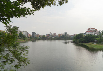 Fototapeta premium Reflection of Hanoi Downtown Skyline, Vietnam with lake and river. Financial district and business centers in smart urban city in Asia. Skyscraper and high-rise buildings.