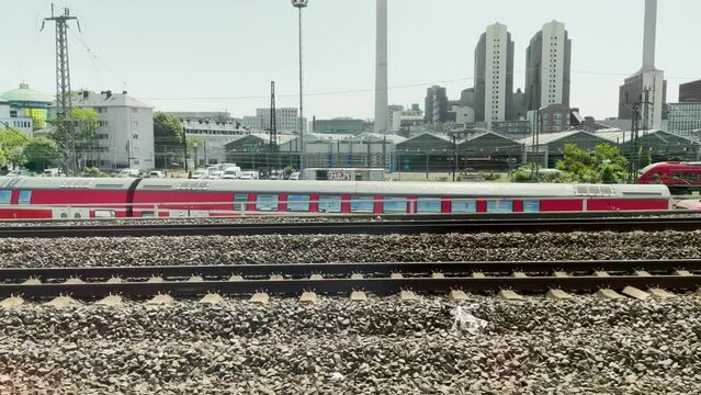 Frankfurt, Germany - May 2023: Arriving by train to the main, central train station of Frankfurt Hauptbahnhof with views of trains, tracks and cityscape industry 