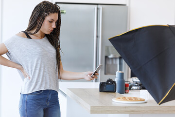 Resilience and dedication: A woman and her camera and smartphone