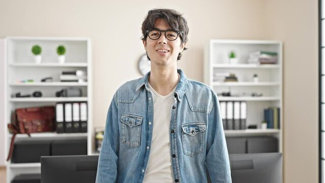 Young hispanic man business worker smiling confident at office