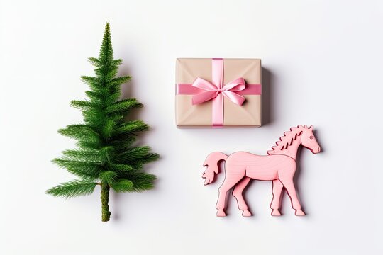 festive border: Merry Christmas and Happy New Year. On a white background, there is a green tree, a gift box with a pink ribbon, and a wooden toy horse. Holiday flat lay photography. Generative AI