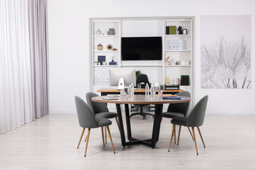 Fototapeta na wymiar Stylish office with comfortable furniture and tv zone. Interior design
