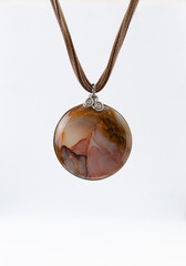 "Earthly charm: I said marble onyx medallion in nickel silver and suede leather"