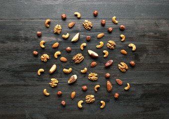 Fototapeta na wymiar Pattern of nuts mix on wooden background