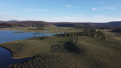Frenchman Lake reservoir in California west shore hills and trees drone high POV photo