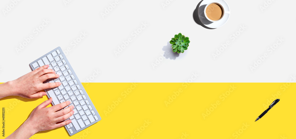 Poster Woman using a computer keyboard - overhead view