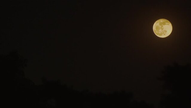 Wide and close up of full moon in Mexico City. Moon in the sky. Cloudy night. Still