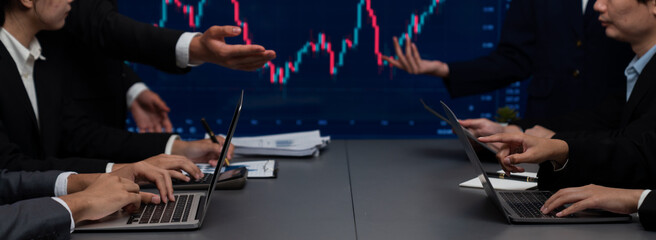 Group of stock trading investor or business people discussing and analyzing financial data graph on stock market together in meeting room. Stock trading or exchange investment planning. Trailblazing
