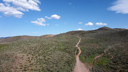 OHV area with rutted paths going up into green mountains