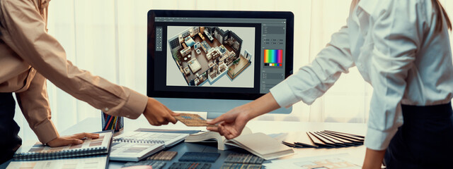 Group of interior architect designer team at table choosing various mood board samples with...