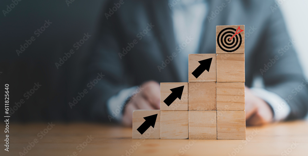 Poster virtual target board and increasing arrow which print screen on wooden cube. setup business achievem