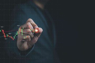 Businessman drawing virtual technical graph and chart for analysis stock market, technology investment and value investment concept.