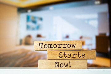 Wooden blocks with words 'Tomorrow Starts Now'.