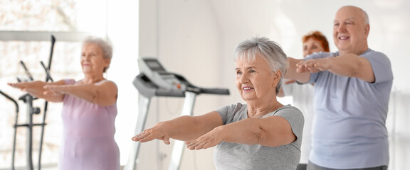 Elderly people exercising in gym