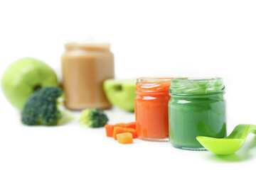 Jars of healthy baby food on white background