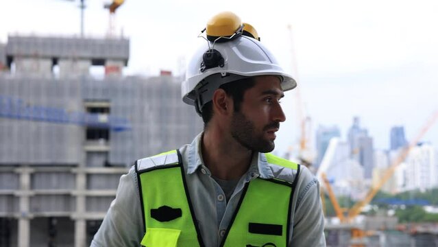 Slow-motion Construction engineer hard working on site of new building construction,  engineer using walkie talkie communicate with team at site line of construction