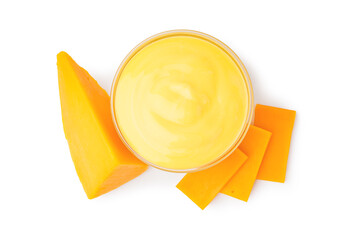 Bowl with tasty cheddar sauce and chunks of cheese on white background