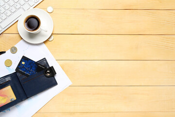 Wallet with credit card and cup of coffee on wooden table