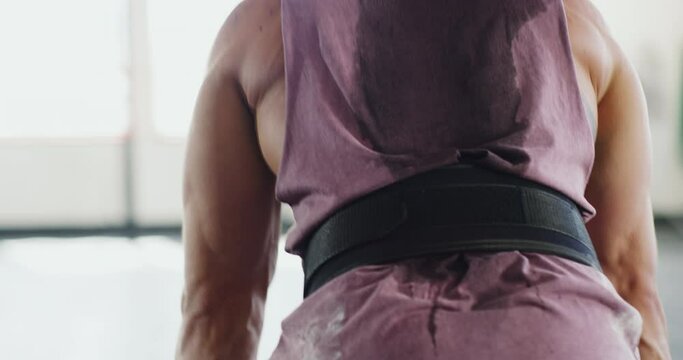 Weightlifting, barbell and man with belt for workout, bodybuilder training and exercise in gym. Fitness, sports and male person lift heavy weight with power, muscles and strong arms for strength