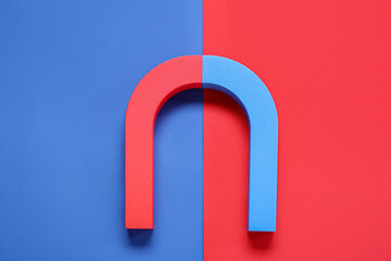 Horseshoe shaped magnet on color background