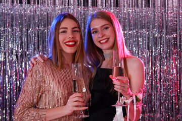 Young women drinking champagne on prom night, closeup - obrazy, fototapety, plakaty