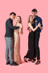 Beautiful prom couples dancing on pink background © Pixel-Shot