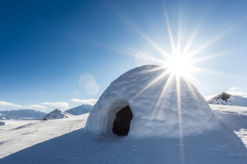 real snow igloo in the mountains under blue sky and sun - obrazy, fototapety, plakaty