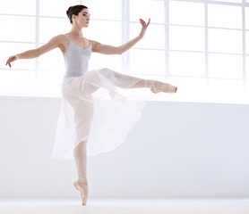 Dance, ballet and moving with woman in studio for balance, elegant and performance. Artist, theatre and training with female ballerina dancing in class for competition, freedom and commitment