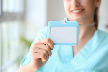 Female medical intern with badge at hospital, closeup