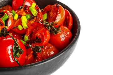 Frying pan with tasty grilled tomatoes and green onion on white background