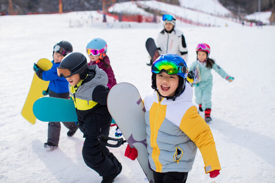 Cheerful children with their coach in ski resort