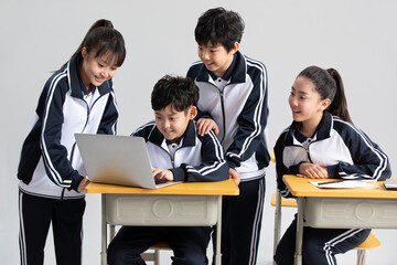 Students learning with laptop in classroom