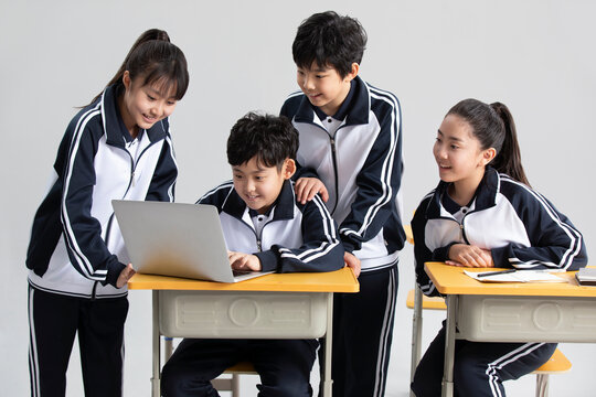 Students learning with laptop in classroom