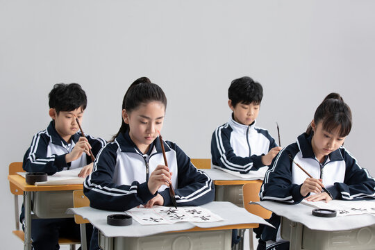 Students practicing calligraphy in classroom