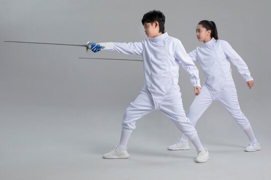 Cute girl and boy in fencing suit