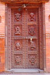 Carved door of a Buddhist temple or monastery in the old city in Bhaktapur, Nepal.