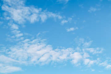 Naklejka na ściany i meble Background of blue sky with white clouds