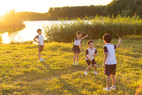 Cheerful school children playing in park