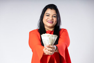 Indian woman showing five hundred bank note on white background.