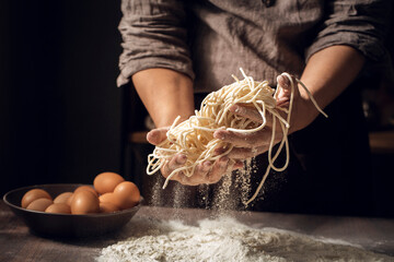 Midsection of chef making noodles