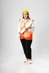 Indian woman engineer wearing yellow color hard hat and checking paper on white background.