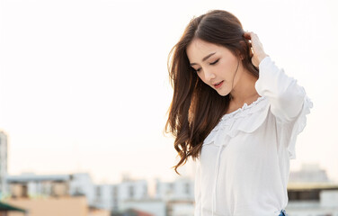 Portrait of young beautiful innocence asian woman in sky roof top. Smile face asian girl wear...