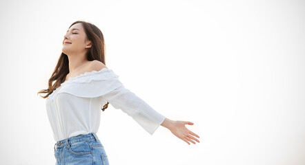 Portrait of young beautiful asian woman hands gesture in open arms on city sky air roof top. Smile...