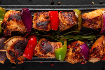 Grilled chicken breast meat barbecue skewers with vegetables. Shish kebab or shashlik. top view....
