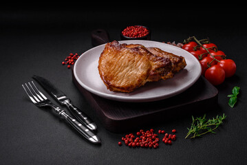 Delicious juicy pork or beef steak with salt, spices and herbs